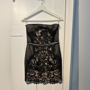 Strapless black lace dress with nude underlayer